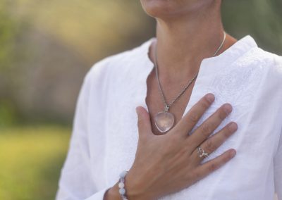 person meditating with hand over heart