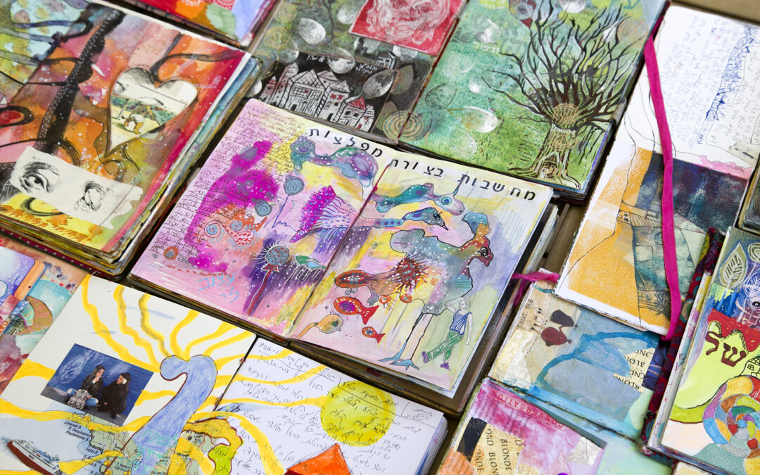 Dozens of SoulPages journals lying open side by side, every spread different