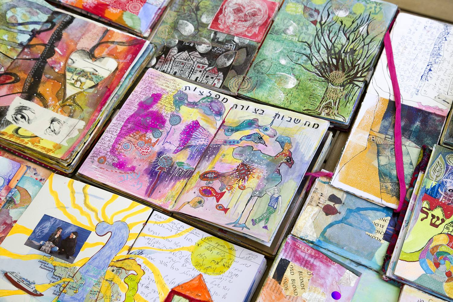 Dozens of SoulPages journals lying open on a table