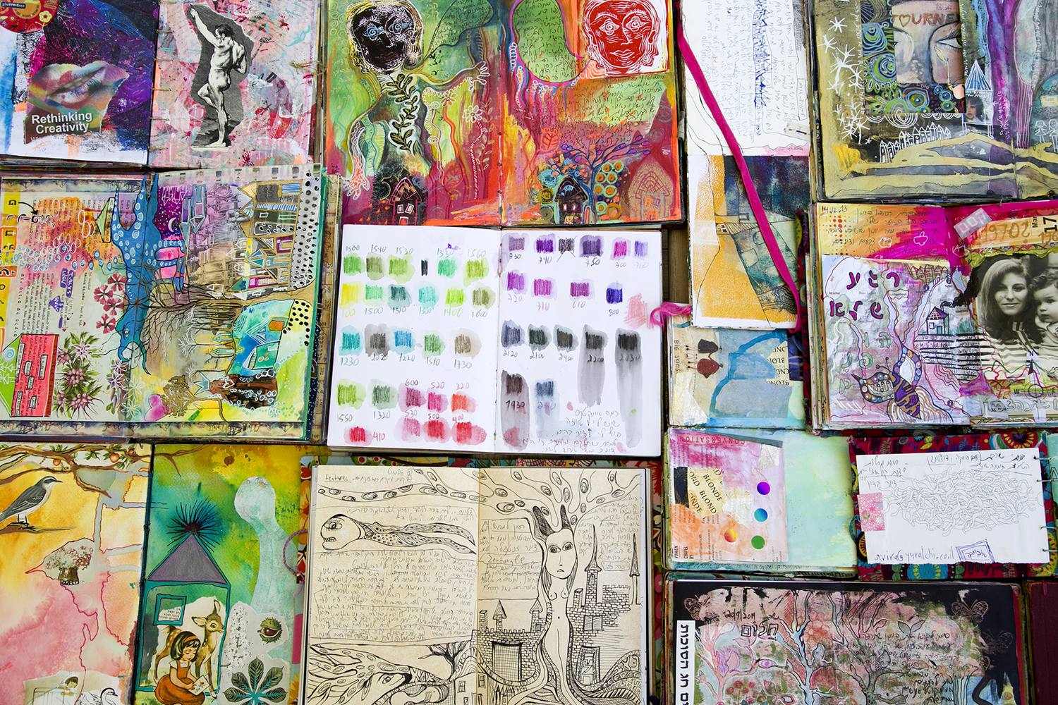 A wall of finished SoulPages journals, every spread different